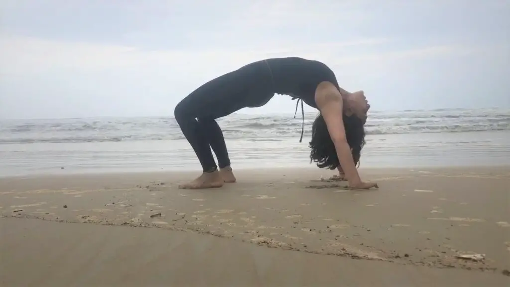 Attempting Chakrasana on Majorda beach