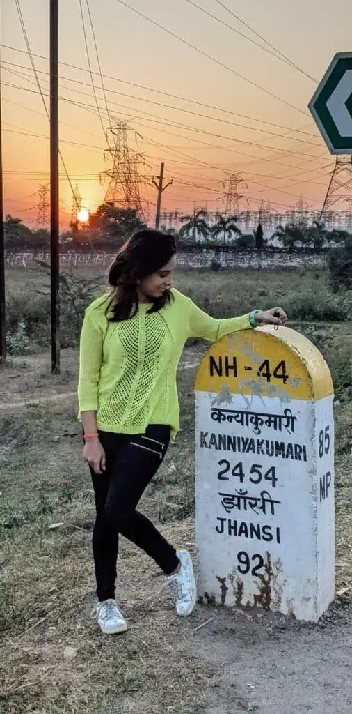 Posing with a milestone on NH44